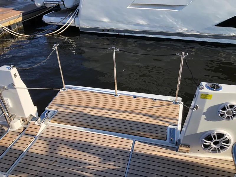 Slide: The Image of 2024 Jeanneau Leader 12.5 WA boat deck with wooden flooring and railing. - 20