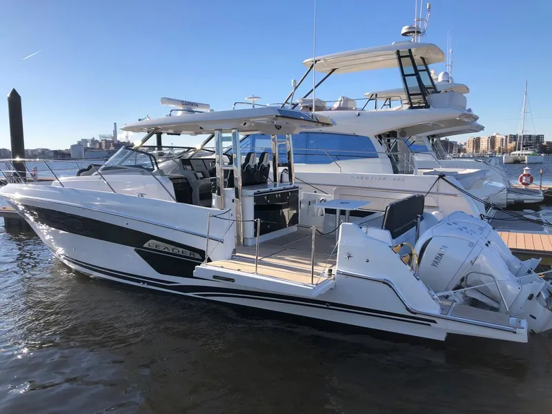 Slide: The Image of 2024 Jeanneau Leader 12.5 WA boat docked in marina, side view. - 21
