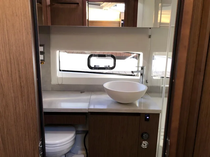 Slide: The Image of 2024 Jeanneau Leader 12.5 WA bathroom with modern sink and wooden cabinetry. - 27
