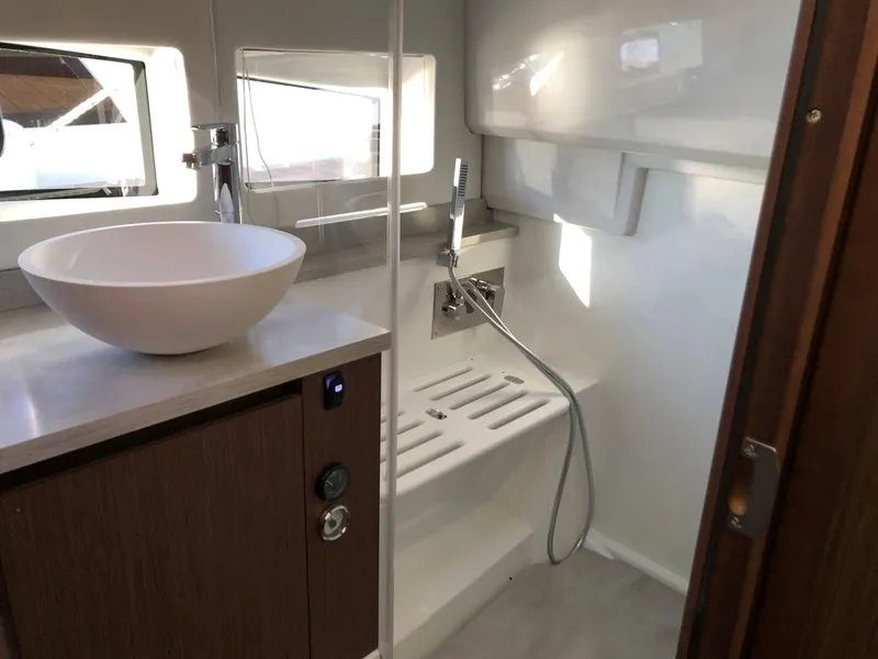 Slide: The Image of 2024 Jeanneau Leader 12.5 WA bathroom with modern sink and shower area. - 28