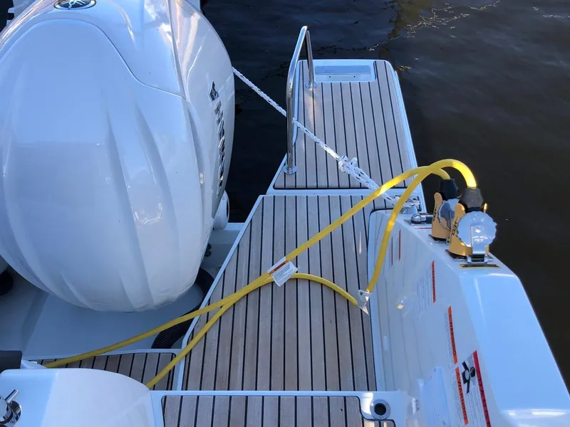 Slide: The Image of 2024 Jeanneau Leader 12.5 WA boat deck with engine and safety equipment. - 6