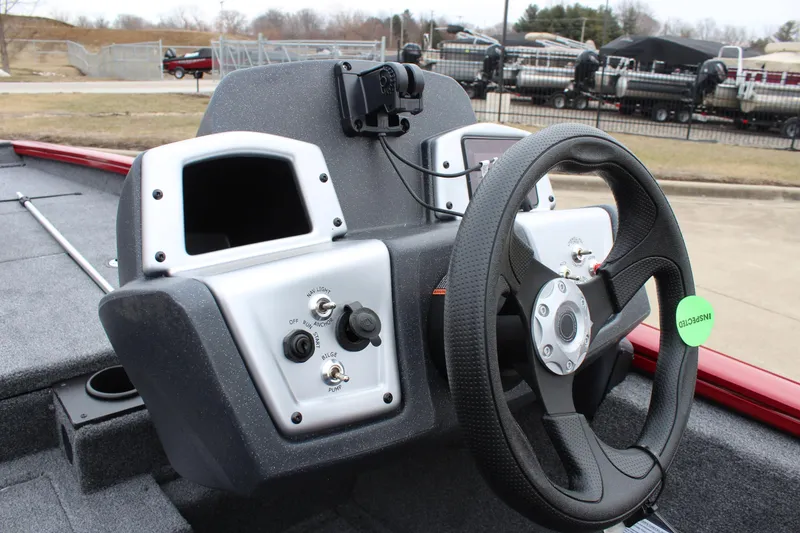 Slide: The Image of 2025 Tracker PT 175 TXW boat dashboard with steering wheel and control panel. - 6