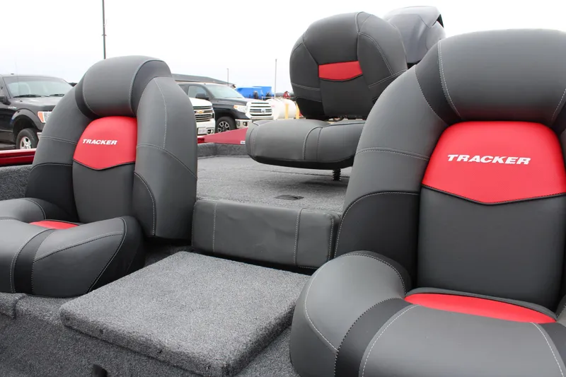 Slide: The Image of 2025 Tracker PT 175 TXW boat seats, gray and red upholstery, outdoor setting. - 8