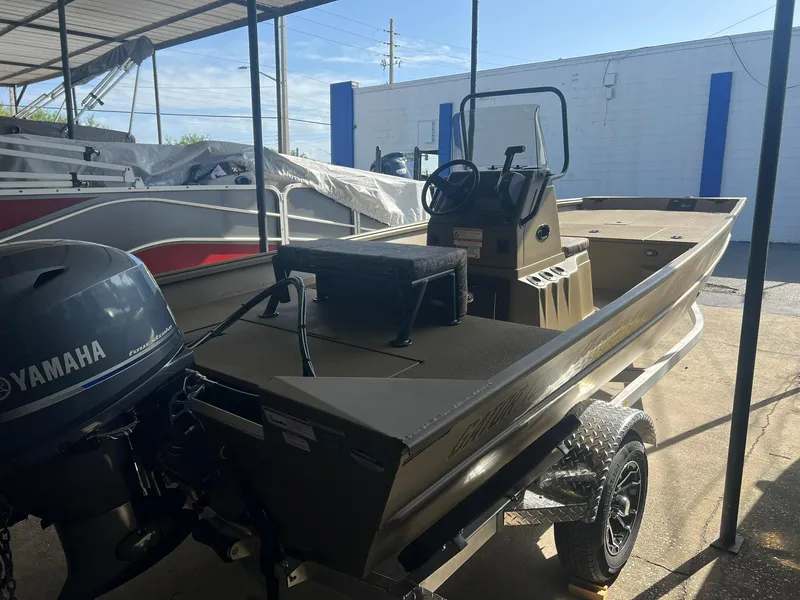 Slide: The Image of 2025 G3 Gator Tough 17 CC boat on trailer, parked outdoors. - 2