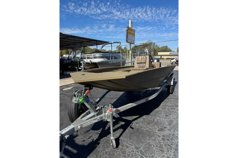 Slide: The Image of 2025 G3 Gator Tough 17 CC boat on trailer under clear blue sky. - 3