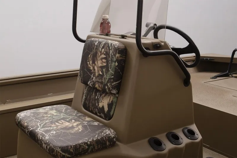 Slide: The Image of 2025 G3 Gator Tough 17 CC boat interior with steering console and camo seating. - 6