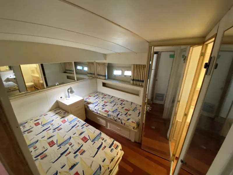 Slide: The Image of Interior cabin of 1982 Bertram 46.6 War Wagon with twin beds and nautical decor. - 27