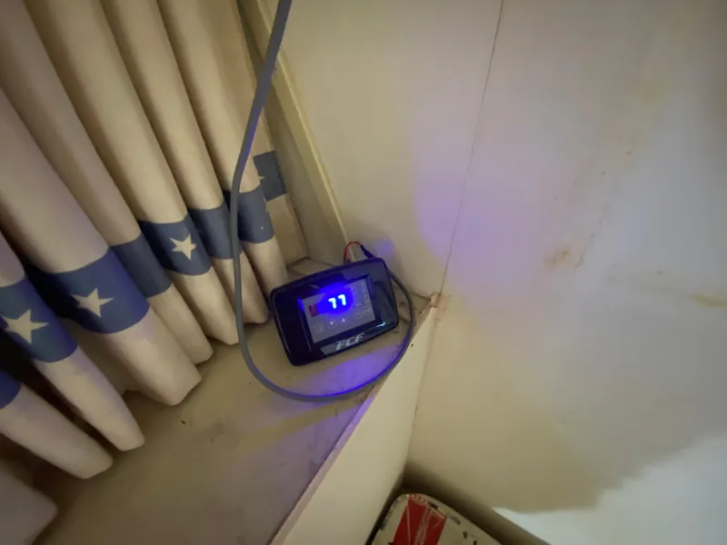 Slide: The Image of Digital display on Bertram 46.6 War Wagon, 1982, near star-patterned curtains. - 32