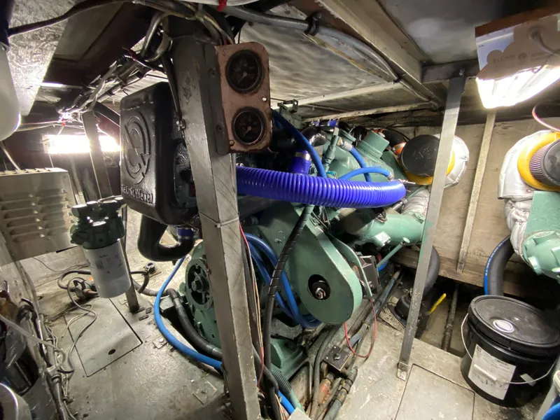 Slide: The Image of Engine room of 1982 Bertram 46.6 War Wagon with visible machinery and wiring. - 38