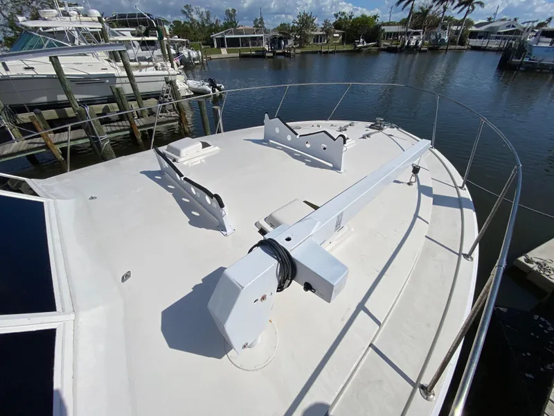 Slide: The Image of 1982 Bertram 46.6 War Wagon yacht deck, docked in a marina with surrounding boats. - 7