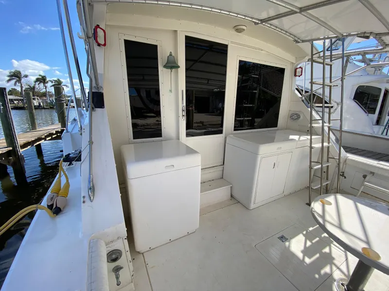 Slide: The Image of 1982 Bertram 46.6 War Wagon yacht deck with storage and seating area. - 12