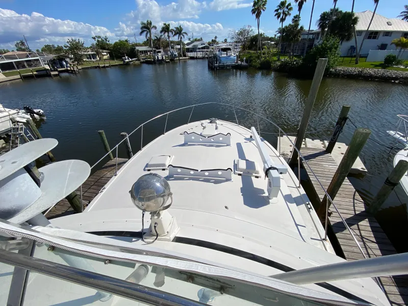 Slide: The Image of 1982 Bertram 46.6 War Wagon yacht docked in a scenic marina. - 19