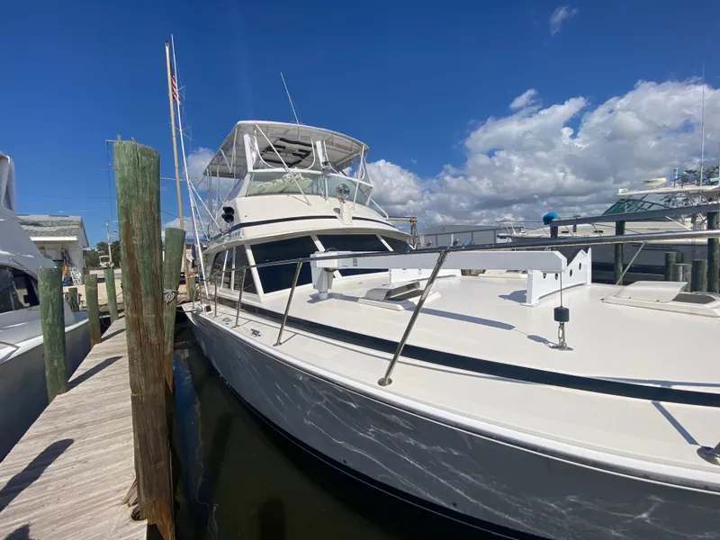 Slide: The Image of 1982 Bertram 46.6 War Wagon yacht docked under clear blue sky. - 3