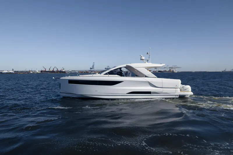 Slide: The Image of 2024 Jeanneau DB/43 OB yacht cruising on open water under clear blue skies. - 19