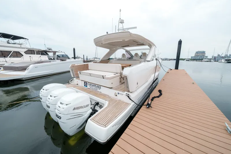 Slide: The Image of 2024 Jeanneau DB/43 OB yacht docked, featuring spacious deck and luxurious seating. - 25
