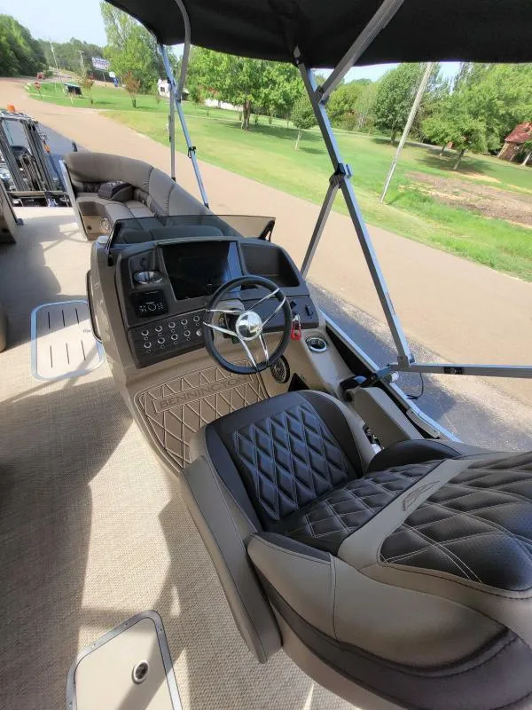 Slide: The Image of 2024 Bennington 25 RSB boat interior with luxurious seating and modern dashboard. - 12