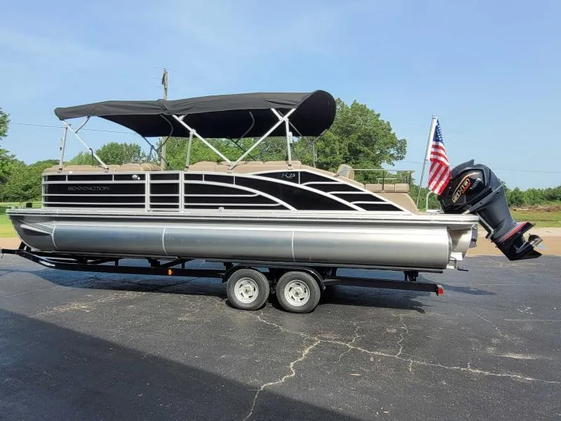 Slide: The Image of 2024 Bennington 25 RSB pontoon boat on trailer with canopy and American flag. - 3