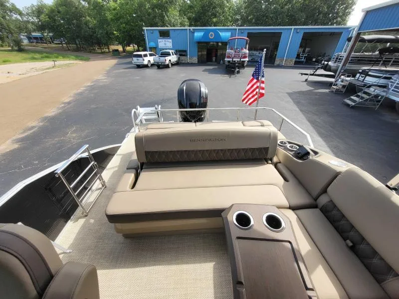 Slide: The Image of 2024 Bennington 25 RSB pontoon boat with luxurious seating and American flag. - 7