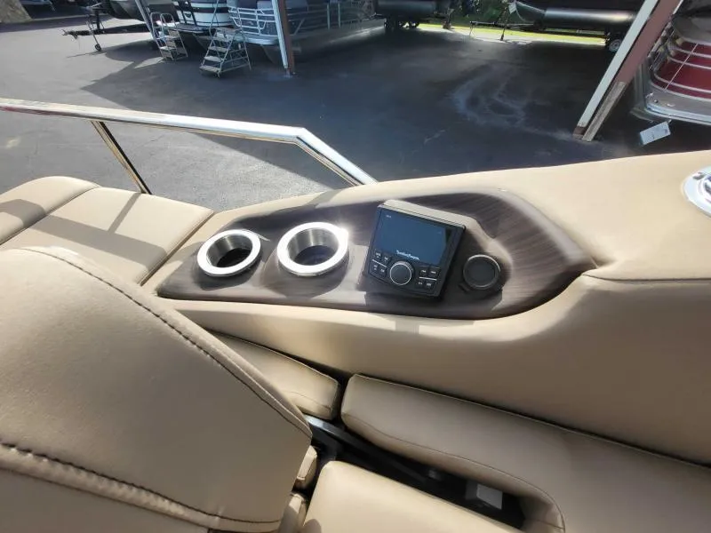Slide: The Image of 2024 Bennington 25 RSB boat interior with cup holders and control panel. - 9