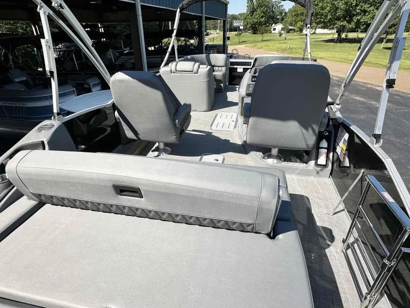 Slide: The Image of 2024 Bennington 23RSB boat interior with gray seating and spacious layout. - 6