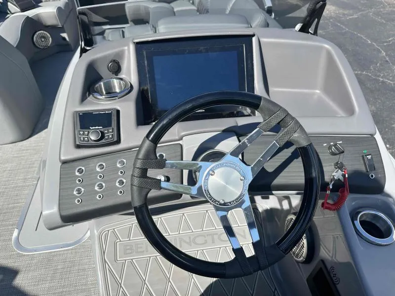 Slide: The Image of 2024 Bennington 23RSB boat dashboard with steering wheel and control panel. - 9
