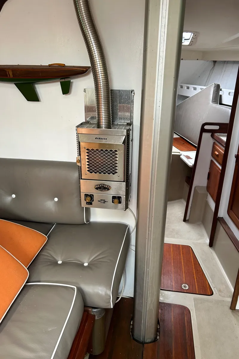 Slide: The Image of Interior of a 1983 O'Day 39 sailboat with seating and a heater. - 20