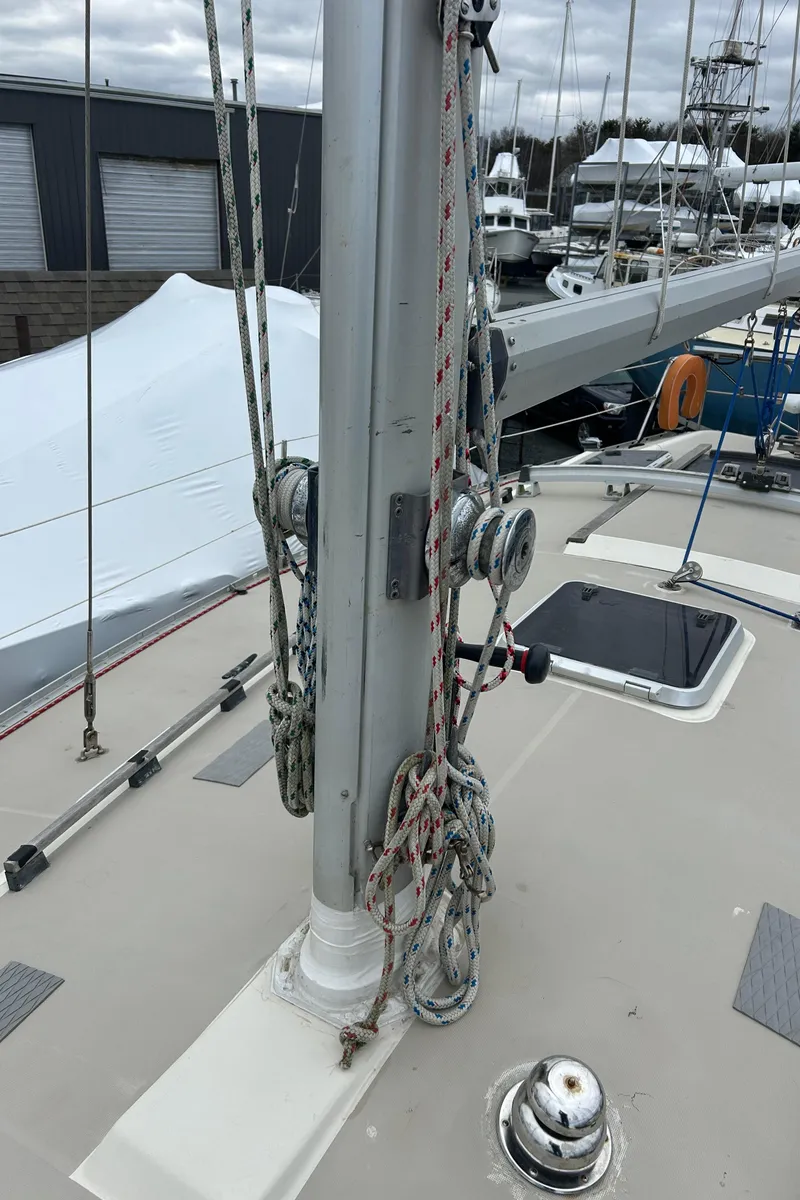 Slide: The Image of 1983 O'Day 39 sailboat deck with mast, ropes, and winches in a marina setting. - 22