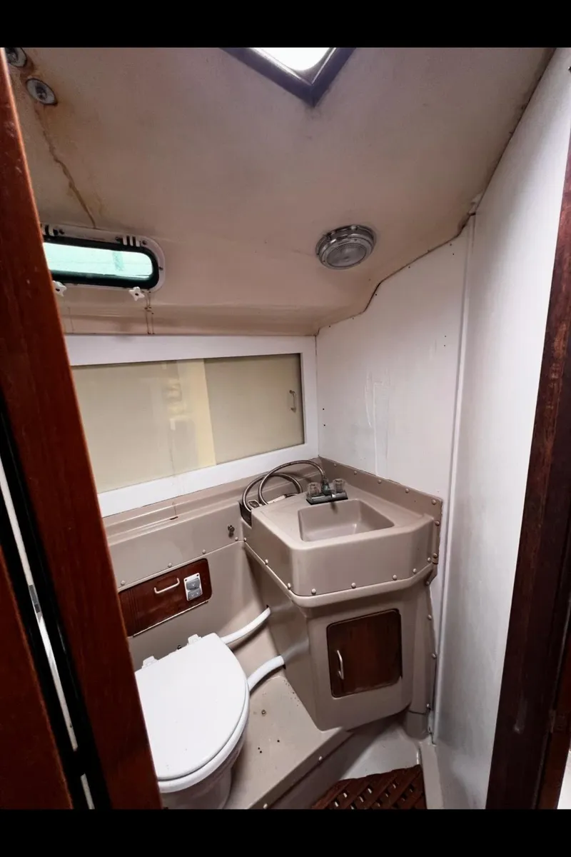 Slide: The Image of 1983 O'Day 39 yacht bathroom with compact sink and toilet. - 25