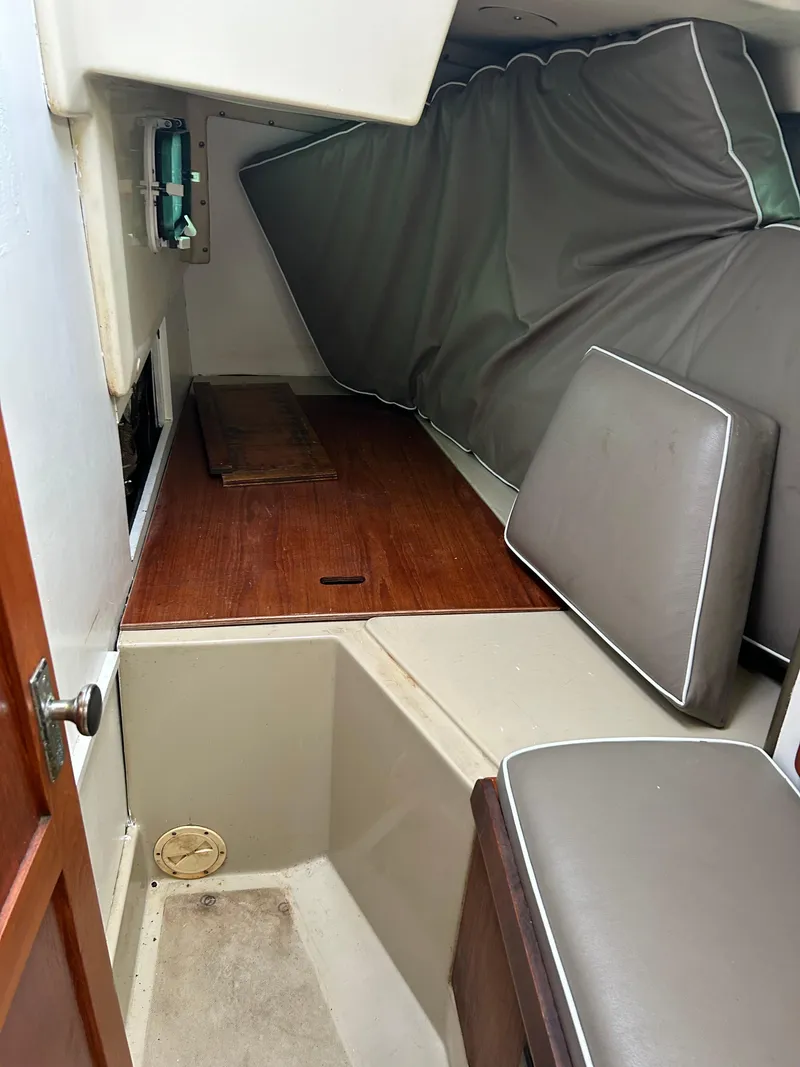 Slide: The Image of Interior cabin of a 1983 O'Day 39 sailboat with cushions and wood flooring. - 4
