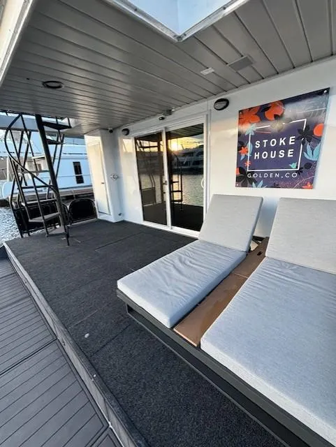 Slide: The Image of 1999 Horizon Stoke House boat deck with lounge chairs and spiral staircase. - 10