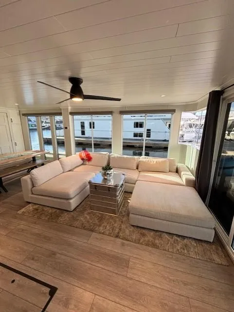 Slide: The Image of Modern living area in 1999 Horizon Stoke Houseboat with large windows and cozy seating. - 12