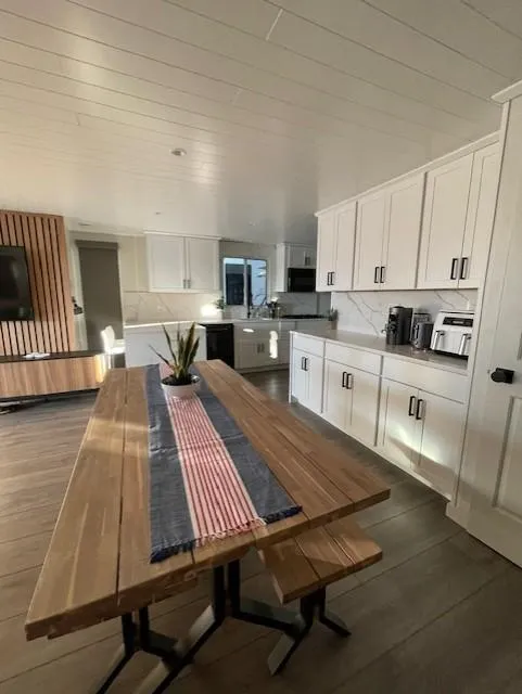 Slide: The Image of Modern kitchen in 1999 Horizon Stoke House with wooden table and white cabinets. - 15