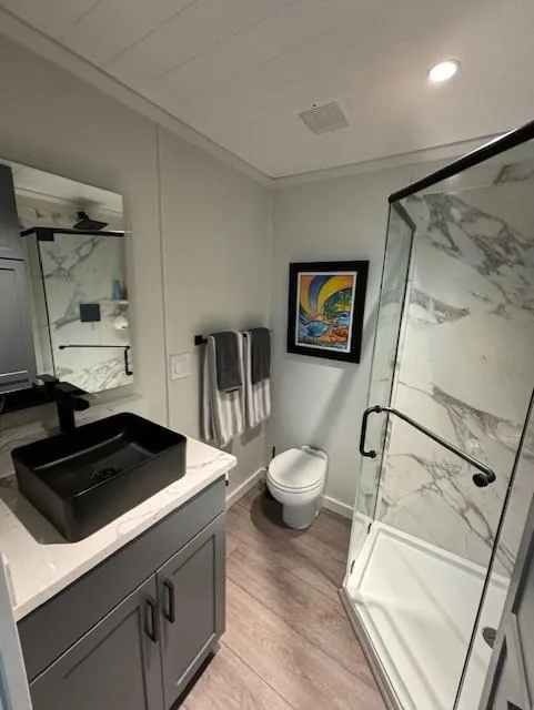 Slide: The Image of Modern bathroom in 1999 Horizon Stoke House with glass shower and black sink. - 20