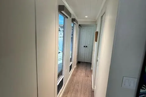 Slide: The Image of Narrow hallway in 1999 Horizon Stoke House with wooden flooring and large windows. - 28