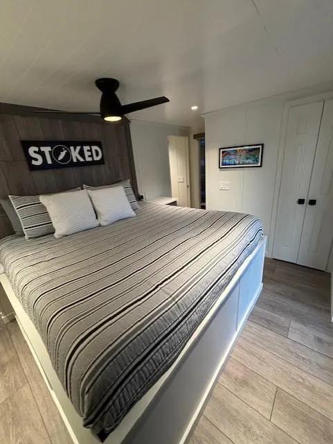 Slide: The Image of Cozy bedroom in 1999 Horizon Stoke House with modern decor and striped bedding. - 29