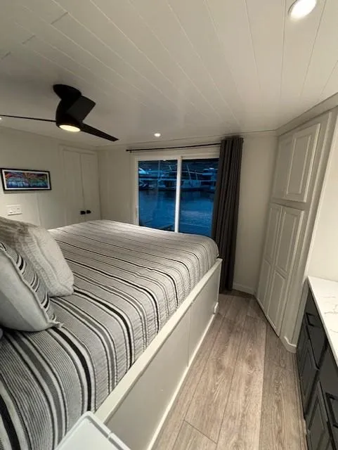 Slide: The Image of Cozy bedroom in 1999 Horizon Stoke House with striped bedding and modern decor. - 30