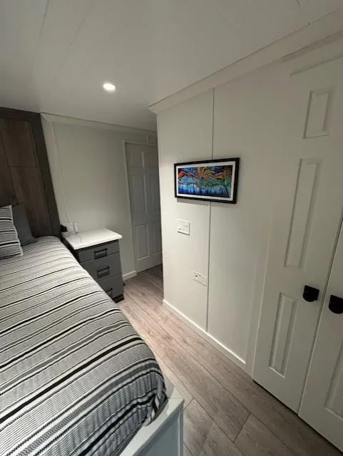 Slide: The Image of Cozy bedroom in 1999 Horizon Stoke House with striped bedding and wall art. - 32