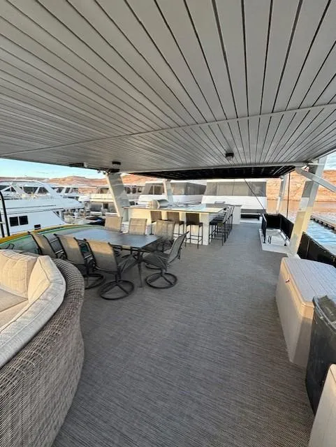 Slide: The Image of Spacious deck of 1999 Horizon Stoke House yacht with seating and bar area. - 39