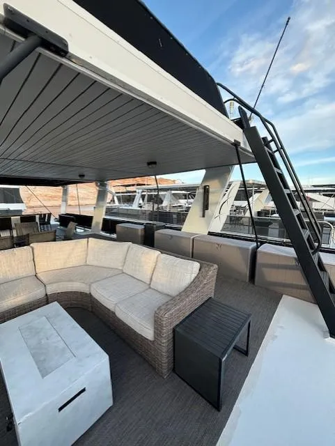 Slide: The Image of Spacious deck of 1999 Horizon Stoke House yacht with modern seating and scenic marina view. - 40