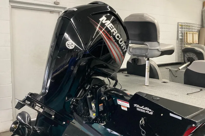 Slide: The Image of 2017 Bass Tracker PRO TEAM 190 TX with Mercury outboard motor in a garage setting. - 4