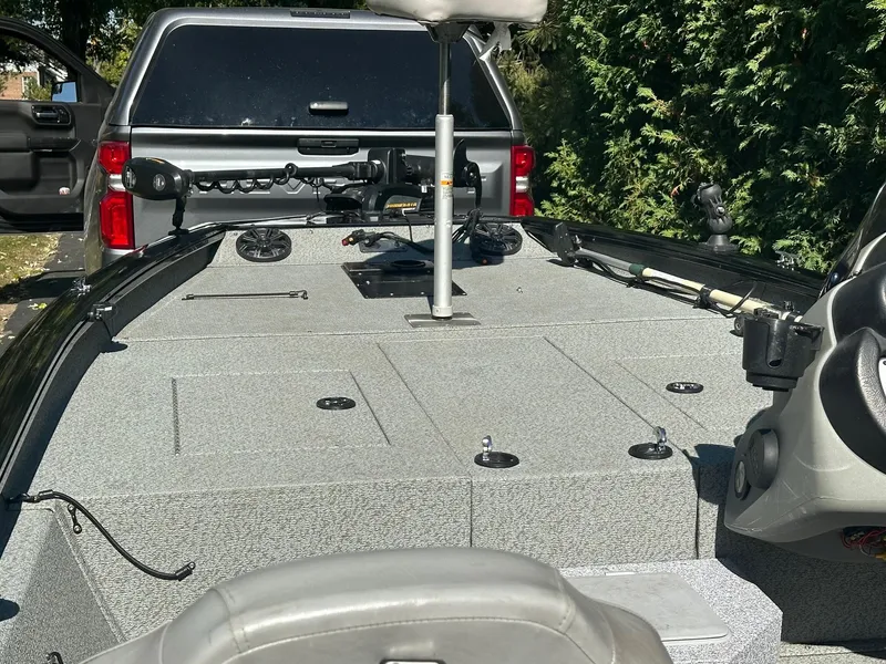 Slide: The Image of 2017 Bass Tracker PRO TEAM 190 TX boat with fishing gear, parked near a truck. - 5