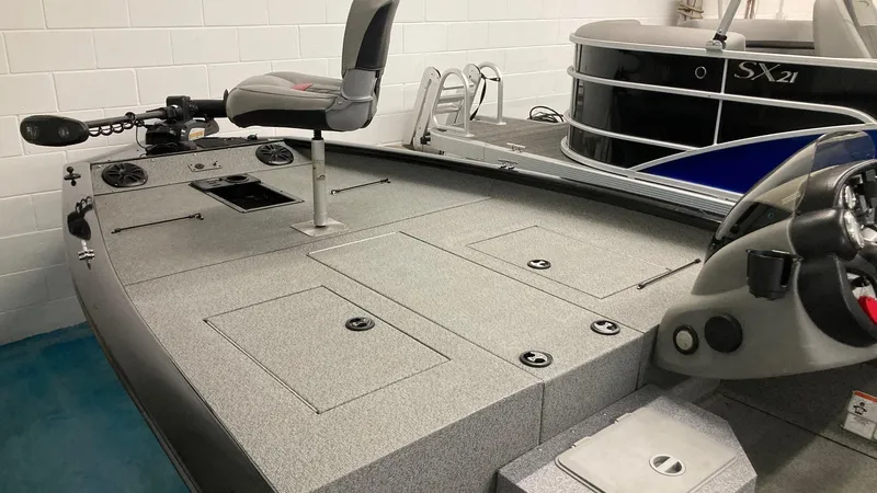 Slide: The Image of 2017 Bass Tracker PRO TEAM 190 TX fishing boat interior with seating and storage compartments. - 7