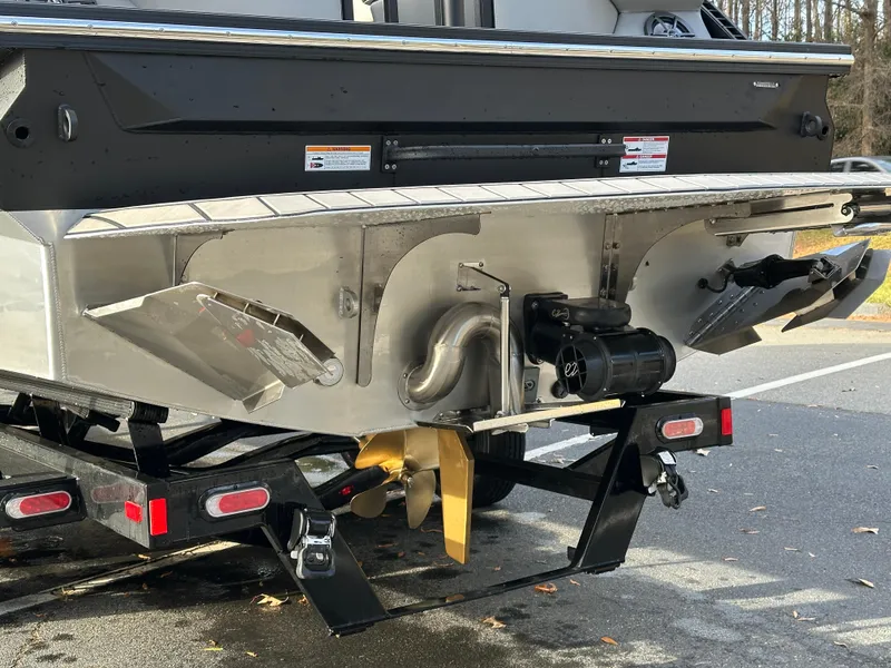 Slide: The Image of 2025 Montara Surf Boss 2.0 25 boat stern with propeller and trailer. - 12