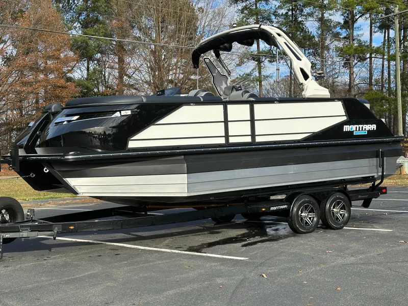 Slide: The Image of 2025 Montara Surf Boss 2.0 25 boat on trailer, parked outdoors. - 15
