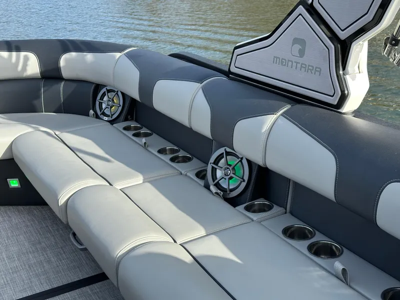 Slide: The Image of Luxurious seating on the 2025 Montara Surf Boss 2.0 25 boat with cup holders and speakers. - 21