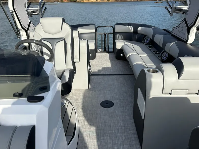 Slide: The Image of 2025 Montara Surf Boss 2.0 25 boat interior with modern seating and steering wheel. - 22