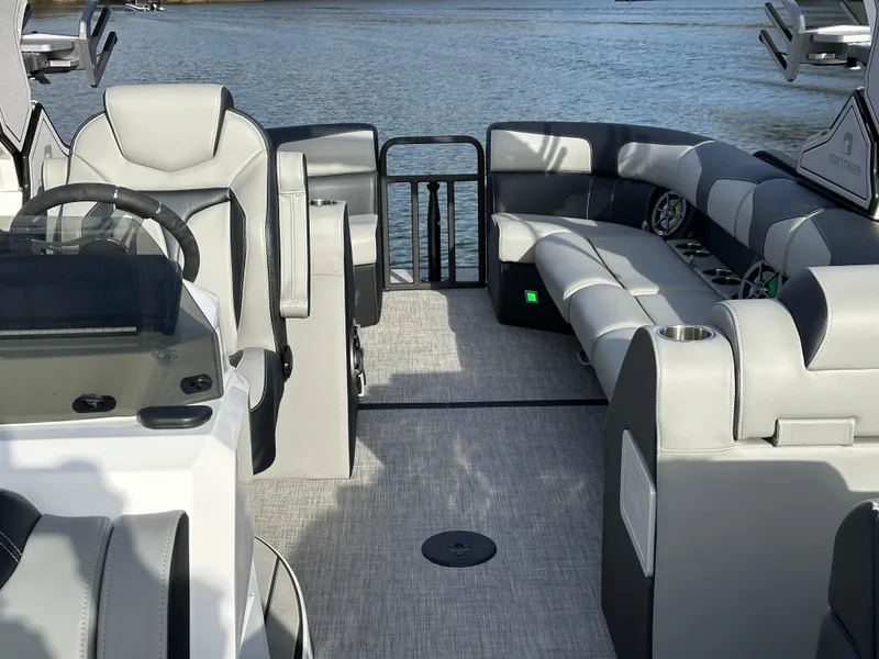 Slide: The Image of 2025 Montara Surf Boss 2.0 25 interior with luxurious seating on a calm lake. - 23