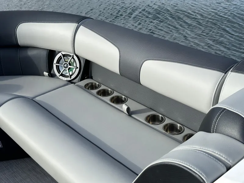 Slide: The Image of Interior seating of 2025 Montara Surf Boss 2.0 25 with cup holders and speaker. - 25