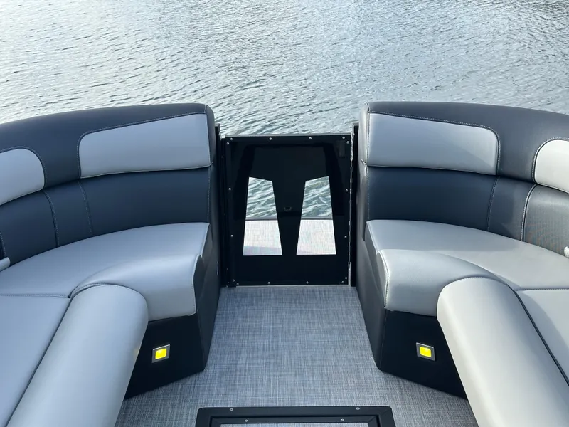 Slide: The Image of 2025 Montara Surf Boss 2.0 25 boat interior with sleek seating on water. - 26
