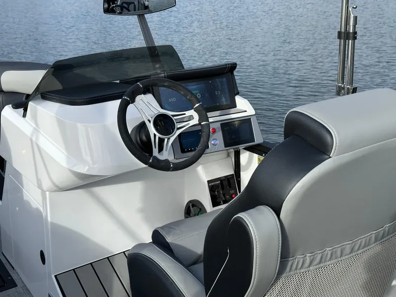Slide: The Image of 2025 Montara Surf Boss 2.0 25 boat interior with modern steering and dashboard controls. - 28